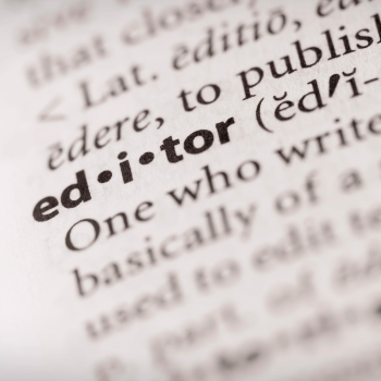 Close-up of a dictionary page showing the word “editor” with its pronunciation and definition.